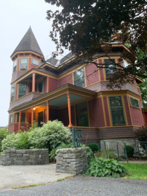 "Red building with yellow trim, stone foundation"